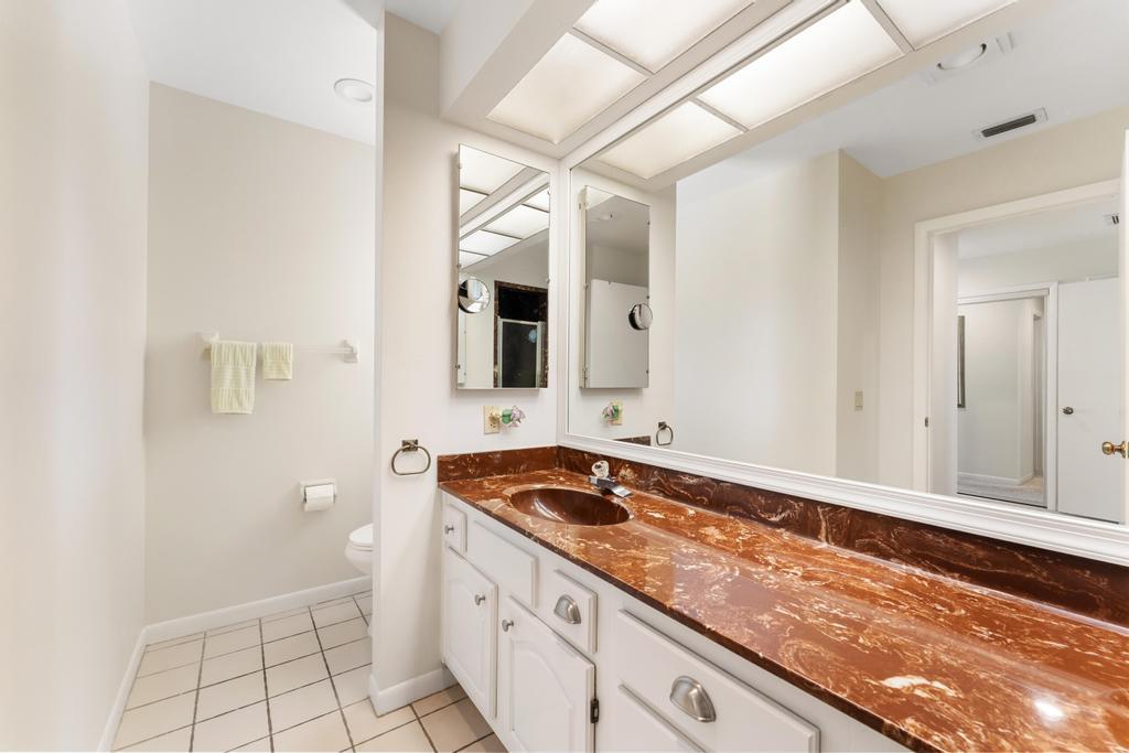 108 Pegasus Drive Jupiter, FL 33477 - Photo 30 of 74 a bathroom with a sink a vanity and a mirror