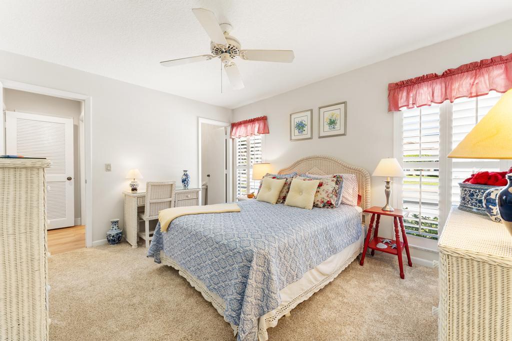 108 Pegasus Drive Jupiter, FL 33477 - Photo 32 of 74 a bedroom with a bed and a chandelier