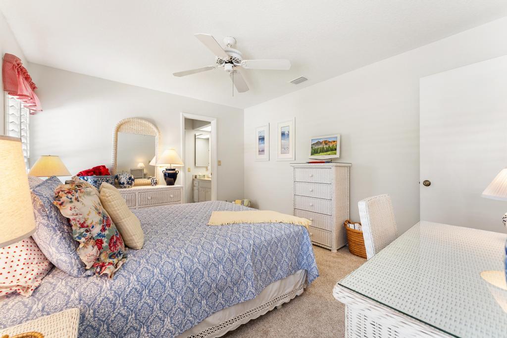 108 Pegasus Drive Jupiter, FL 33477 - Photo 33 of 74 a bedroom with a bed and a chandelier