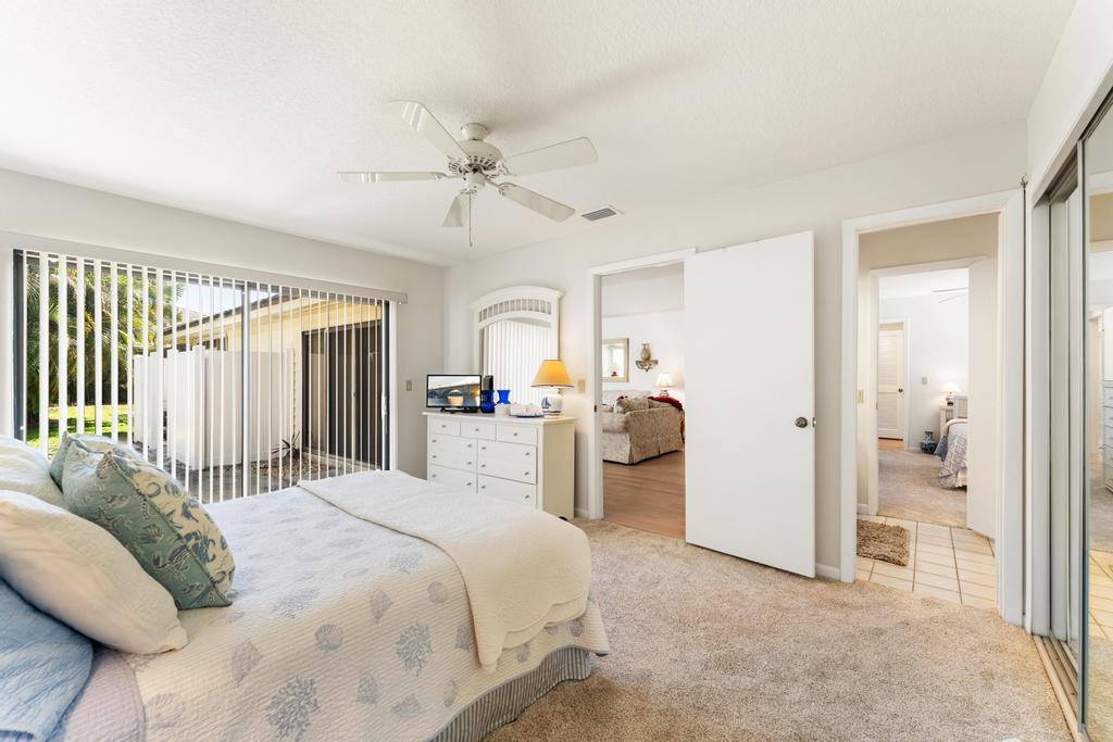 108 Pegasus Drive Jupiter, FL 33477 - Photo 37 of 74 a bedroom with a bed and a chandelier