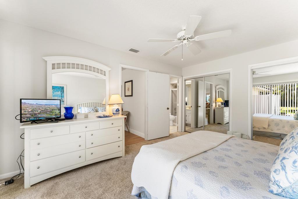 108 Pegasus Drive Jupiter, FL 33477 - Photo 38 of 74 a bedroom with a large bed and a chandelier
