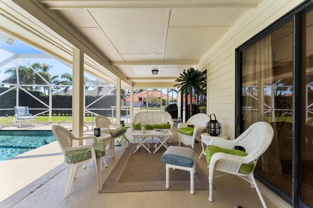 108 Pegasus Drive Jupiter, FL 33477 - Photo 47 of 74 a view of living room with patio furniture and floor to ceiling window