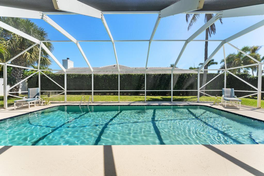 108 Pegasus Drive Jupiter, FL 33477 - Photo 50 of 74 a view of a swimming pool with yard