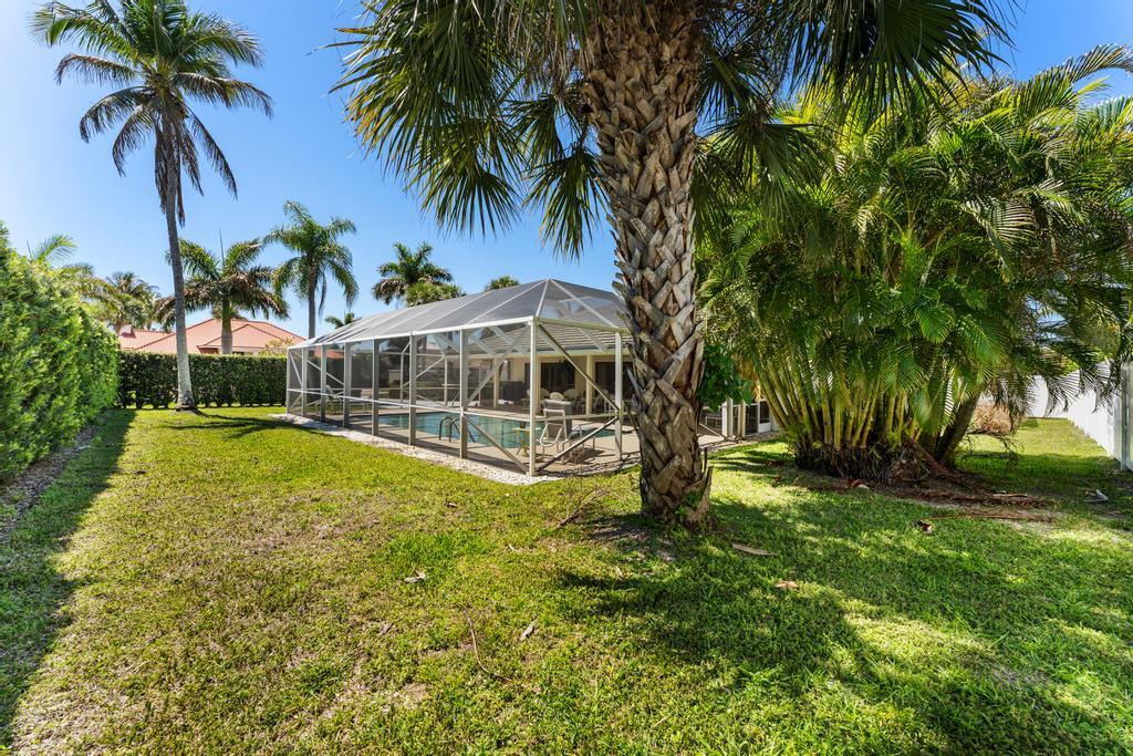 108 Pegasus Drive Jupiter, FL 33477 - Photo 54 of 74 a view of a swimming pool with a garden