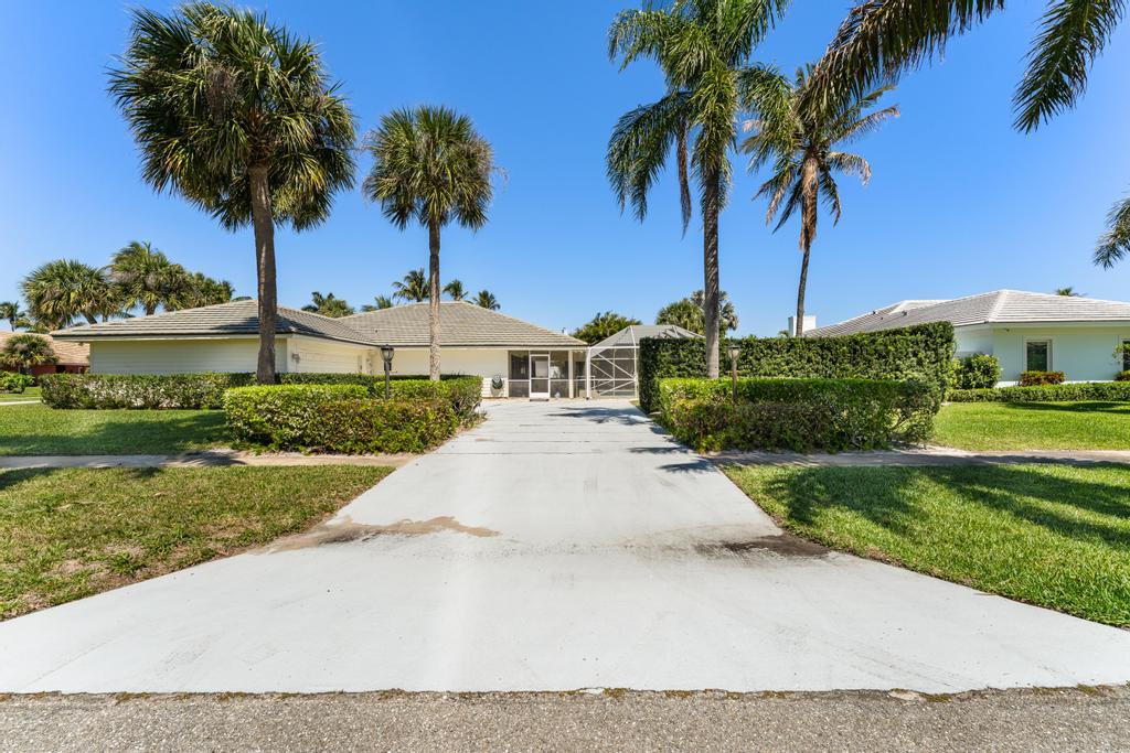 108 Pegasus Drive Jupiter, FL 33477 - Photo 57 of 74 a front view of a house with garden