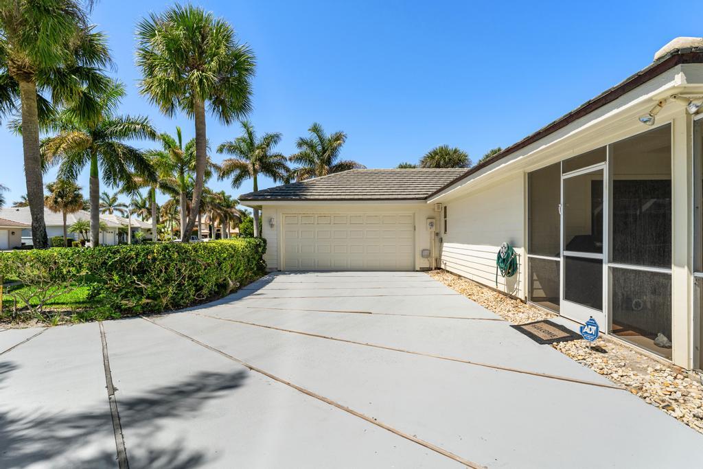 108 Pegasus Drive Jupiter, FL 33477 - Photo 59 of 74 Back Driveway & Garage