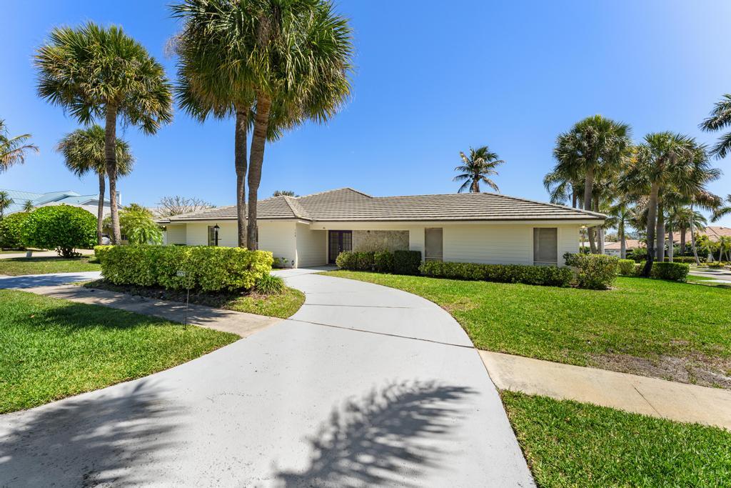 108 Pegasus Drive Jupiter, FL 33477 - Photo 62 of 74 a front view of a house with garden