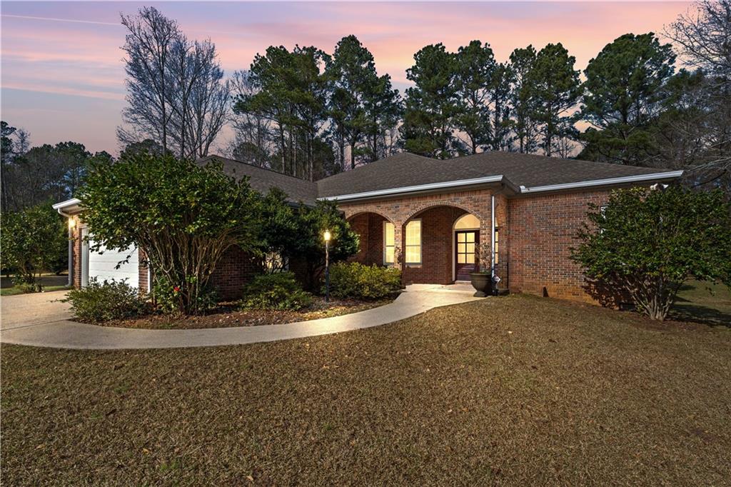 a view of a house with a tree in the background