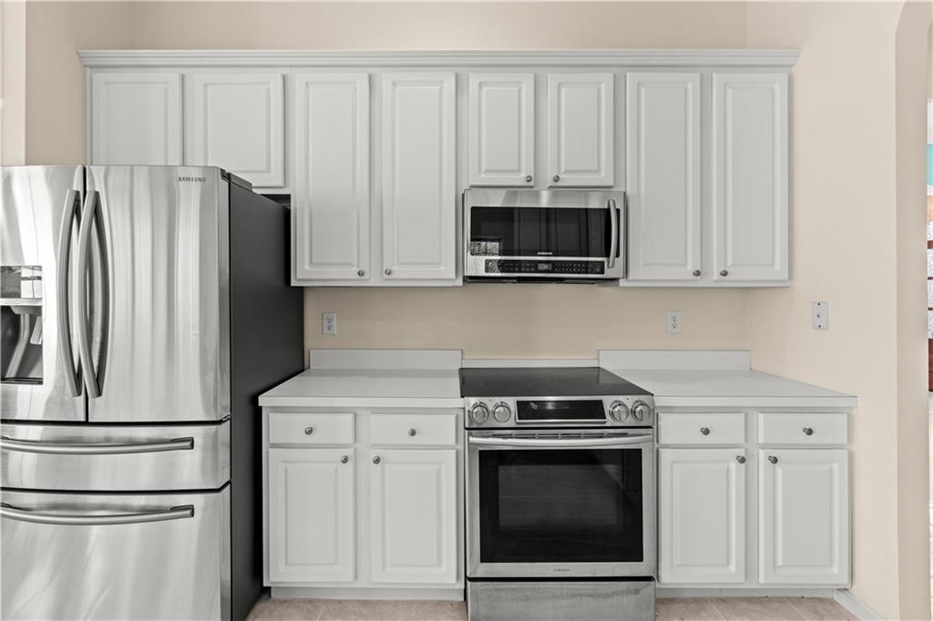 196 Lakeridge Drive Temple, GA 30179 - Photo 12 of 62 a kitchen with white cabinets and stainless steel appliances