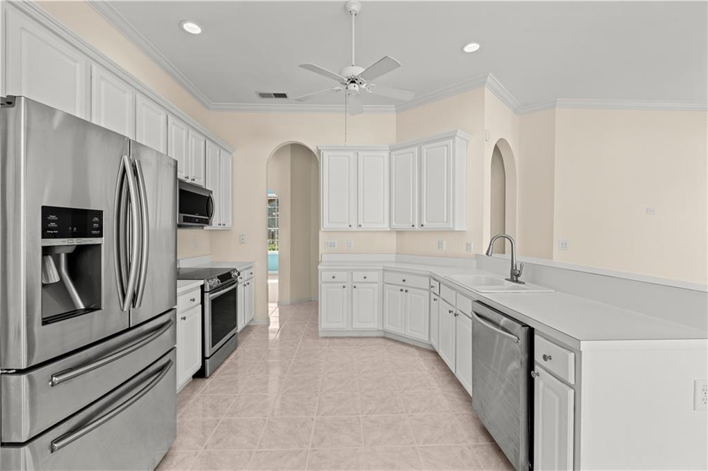196 Lakeridge Drive Temple, GA 30179 - Photo 13 of 62 a large kitchen with stainless steel appliances granite countertop a refrigerator a sink a stove and white cabinets