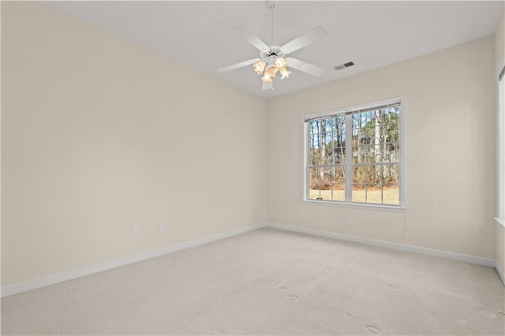 196 Lakeridge Drive Temple, GA 30179 - Photo 23 of 62 an empty room with windows and fan