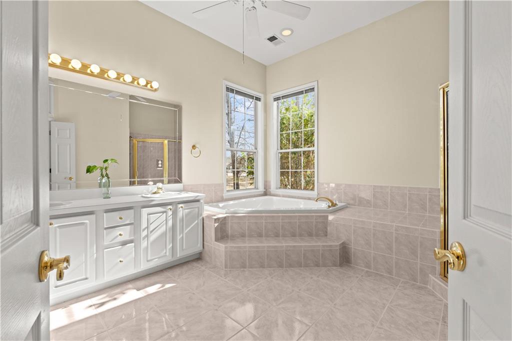 196 Lakeridge Drive Temple, GA 30179 - Photo 27 of 62 a spacious bathroom with a double vanity sink a mirror and a bathtub