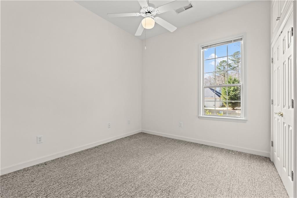 196 Lakeridge Drive Temple, GA 30179 - Photo 34 of 62 an empty room with a window and a fan
