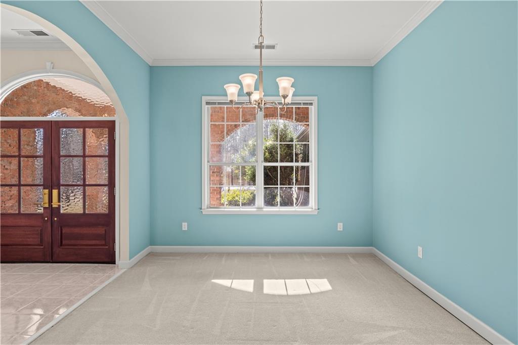 196 Lakeridge Drive Temple, GA 30179 - Photo 39 of 62 an empty room with chandelier fan and windows