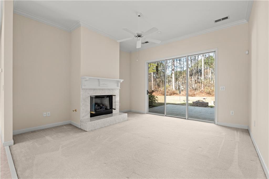 196 Lakeridge Drive Temple, GA 30179 - Photo 40 of 62 a view of an empty room with a fireplace and a window