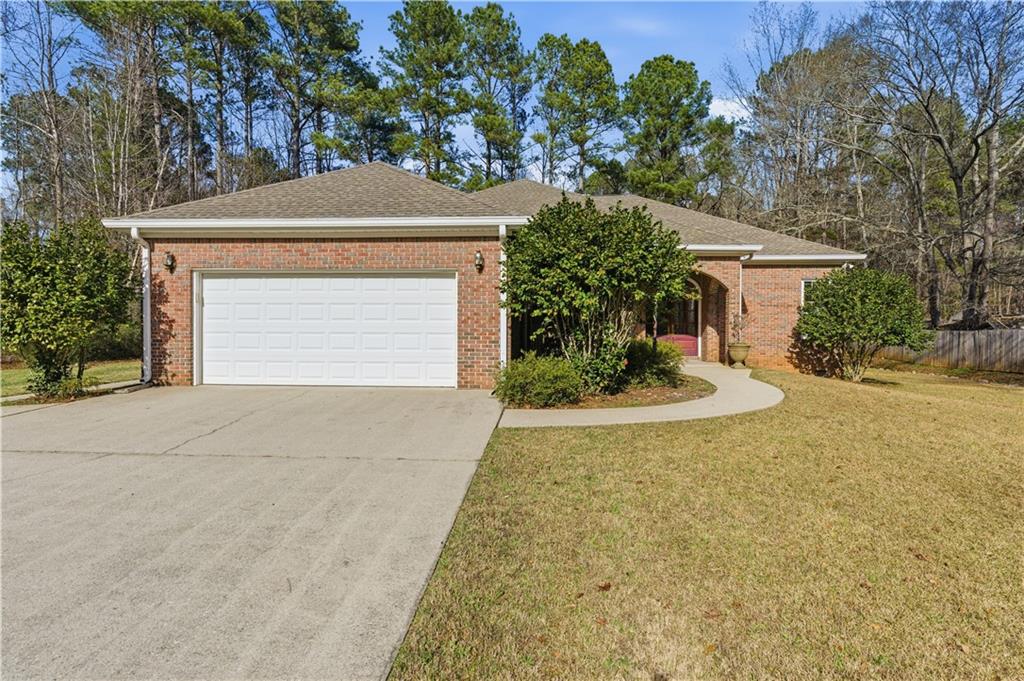 196 Lakeridge Drive Temple, GA 30179 - Photo 58 of 62 a front view of a house with a yard and garage