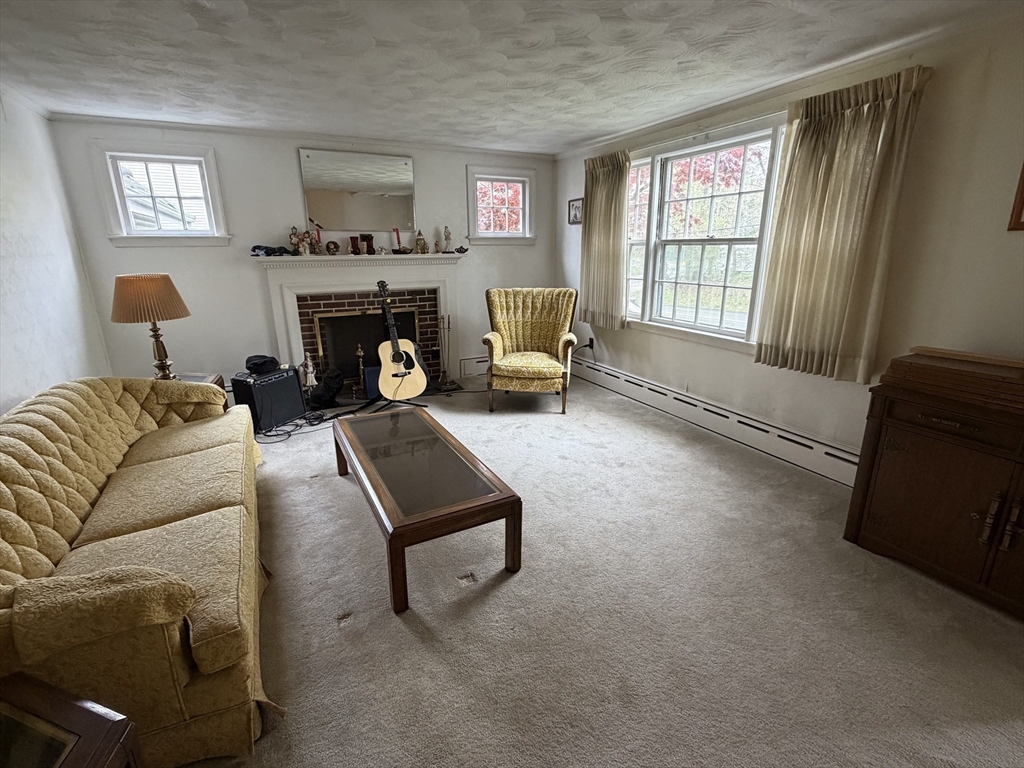 114 Parish Road Needham, MA 02494 - Photo 5 of 20 a living room with furniture and a fireplace