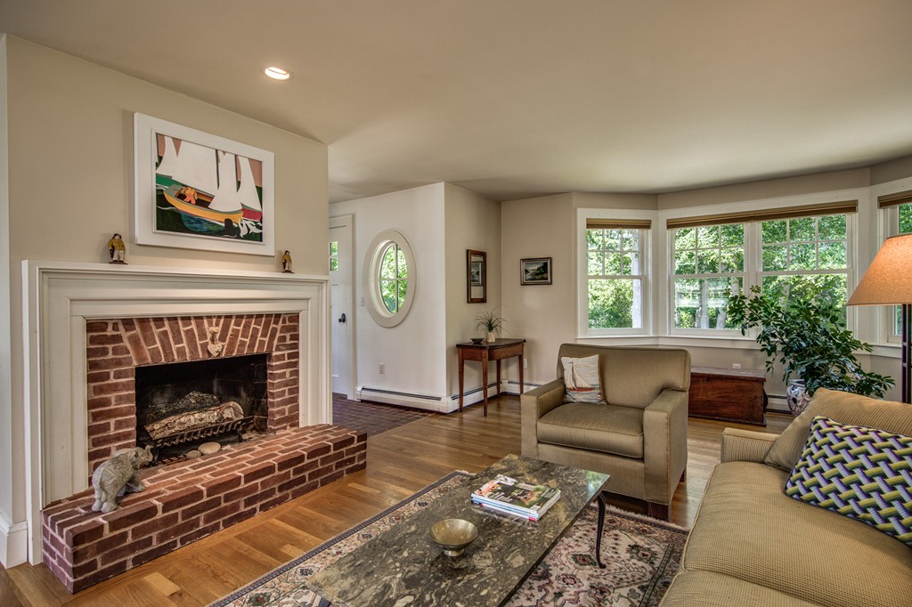 86 Eastern Point Boulevard Gloucester, MA 01930 - Photo 8 of 30 a living room with furniture and a fireplace