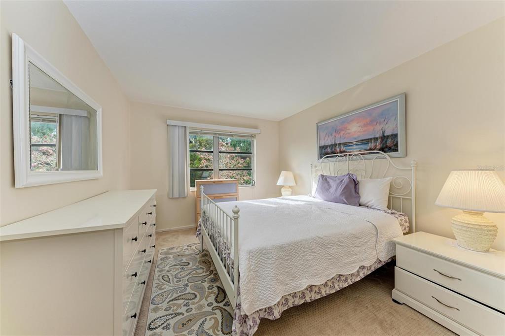5938 Welcome Road, Unit H22 Bradenton, FL 34207 - Photo 20 of 38 a bedroom with a bed and a lamp on dresser