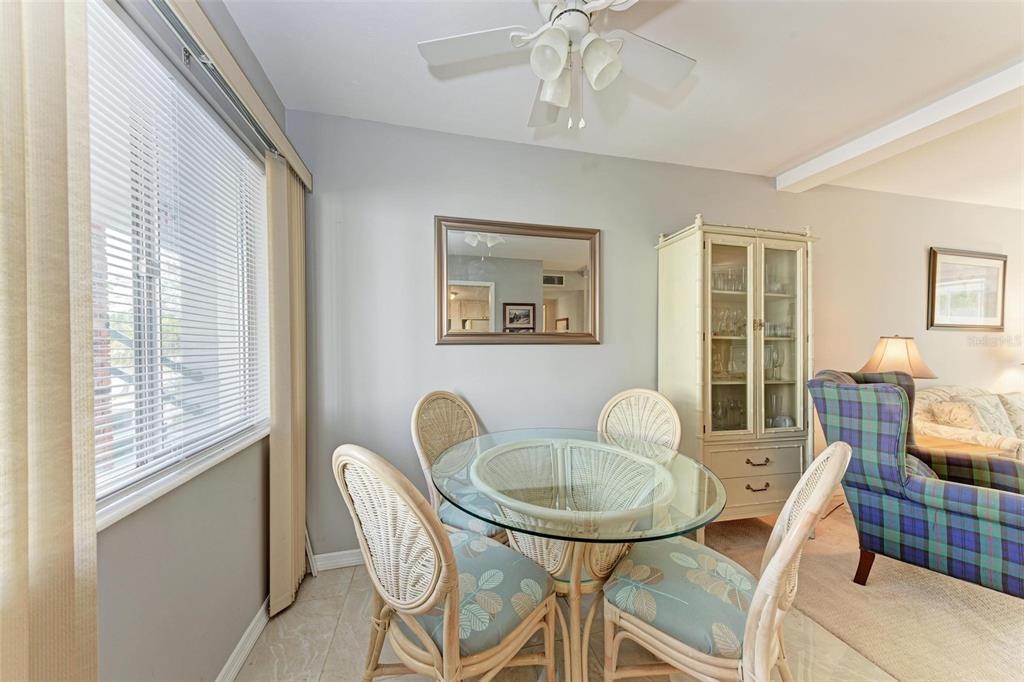 5938 Welcome Road, Unit H22 Bradenton, FL 34207 - Photo 4 of 38 a dining room with furniture a window and a chandelier