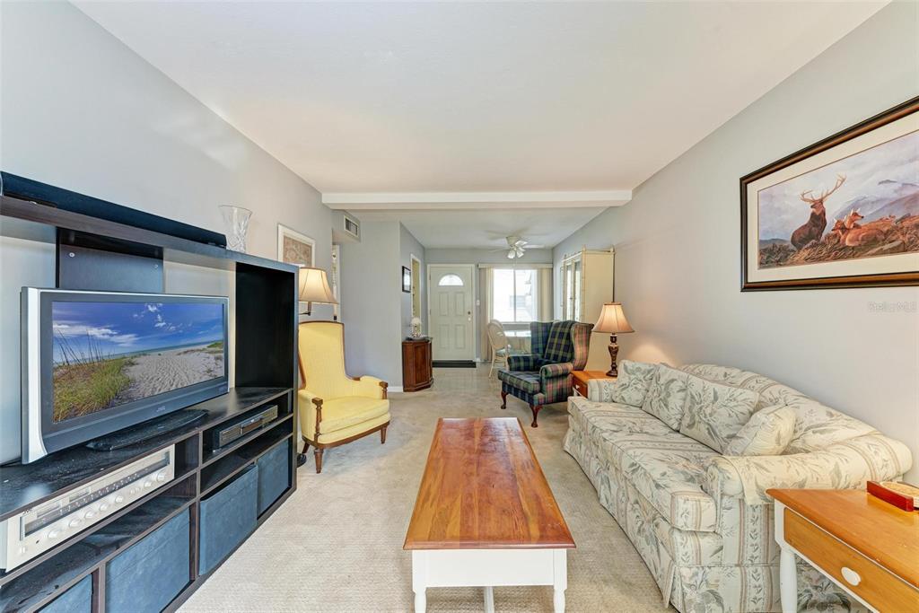 5938 Welcome Road, Unit H22 Bradenton, FL 34207 - Photo 10 of 38 a living room with furniture and a flat screen tv
