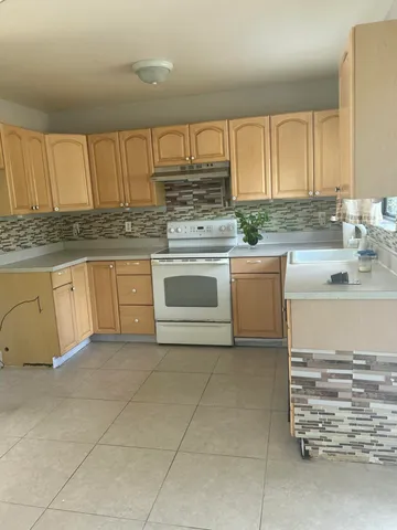 a kitchen with stainless steel appliances granite countertop a sink and cabinets
