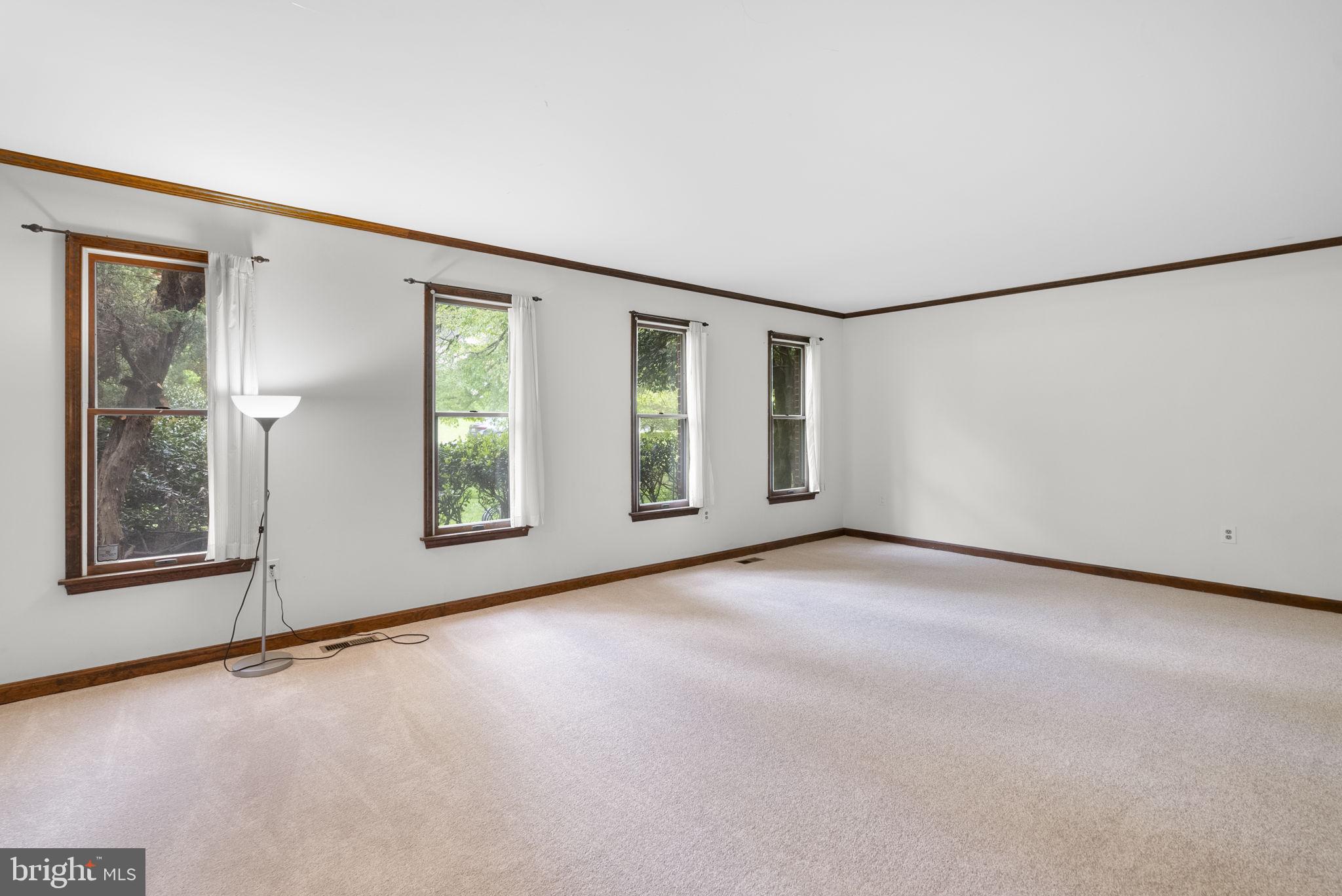 15220 Redgate Drive Silver Spring, MD 20905 - Photo 6 of 65 an empty room with windows and refrigerator