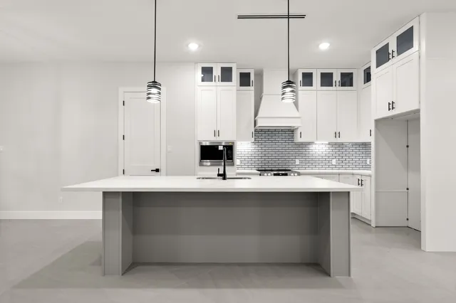 a kitchen with a sink stove and cabinets