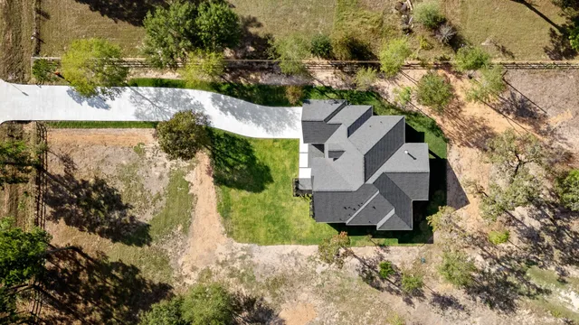 an aerial view of a house with a yard