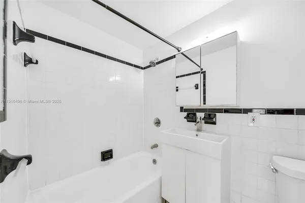 a bathroom with a sink a toilet and a tub
