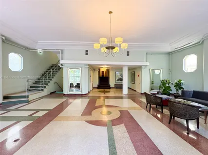 a view of a house with furniture and floor to ceiling window