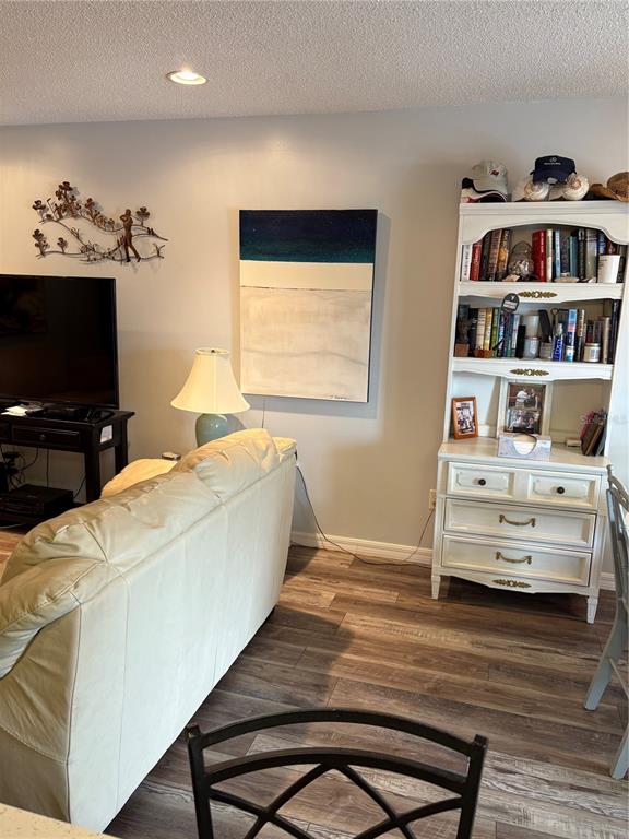 14531 Walsingham Road, Unit 204 Largo, FL 33774 - Photo 13 of 29 a bedroom with a bed and a flat screen tv