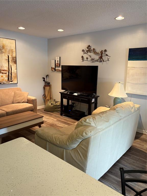 14531 Walsingham Road, Unit 204 Largo, FL 33774 - Photo 14 of 29 a living room with furniture and a flat screen tv