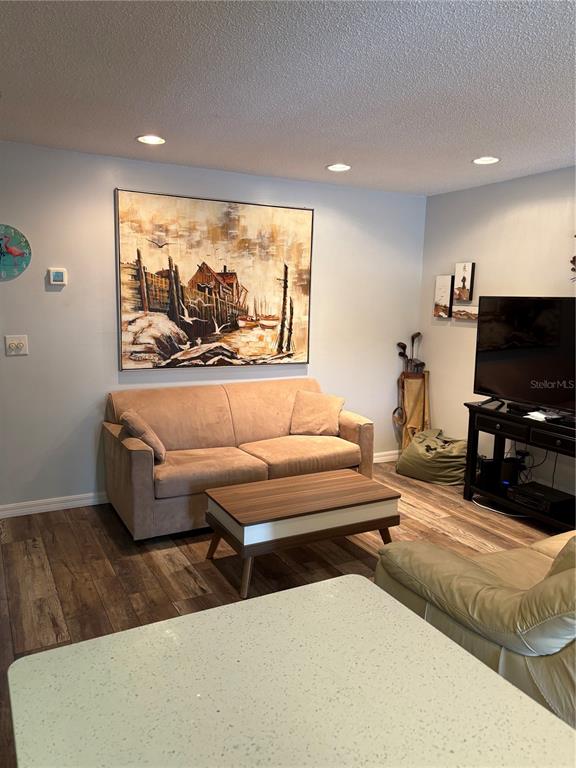 14531 Walsingham Road, Unit 204 Largo, FL 33774 - Photo 15 of 29 a living room with furniture and a flat screen tv