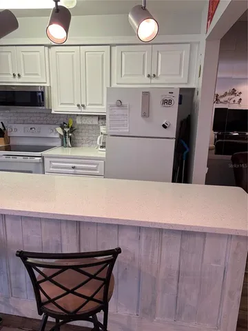 a bedroom with a bed and a ceiling fan