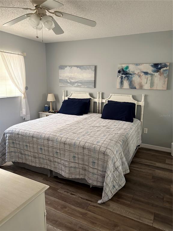 14531 Walsingham Road, Unit 204 Largo, FL 33774 - Photo 22 of 29 a bedroom with a bed and a ceiling fan