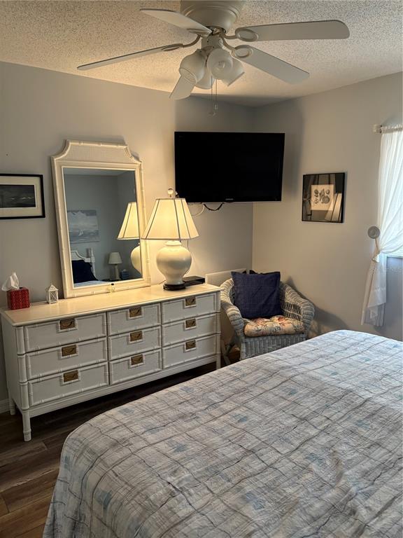 14531 Walsingham Road, Unit 204 Largo, FL 33774 - Photo 24 of 29 a bedroom with a bed and a flat tv screen on dresser