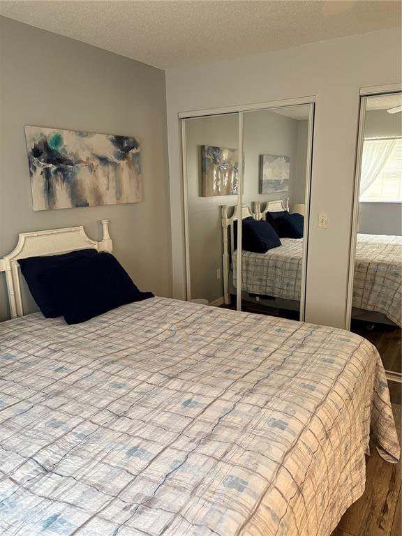 14531 Walsingham Road, Unit 204 Largo, FL 33774 - Photo 25 of 29 a bedroom with a bed and a mirror