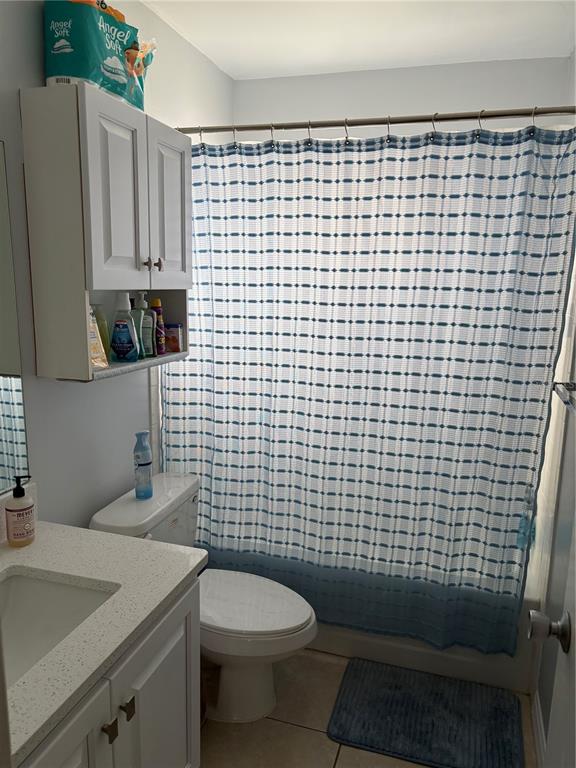 14531 Walsingham Road, Unit 204 Largo, FL 33774 - Photo 26 of 29 a bathroom with a sink a toilet and a mirror