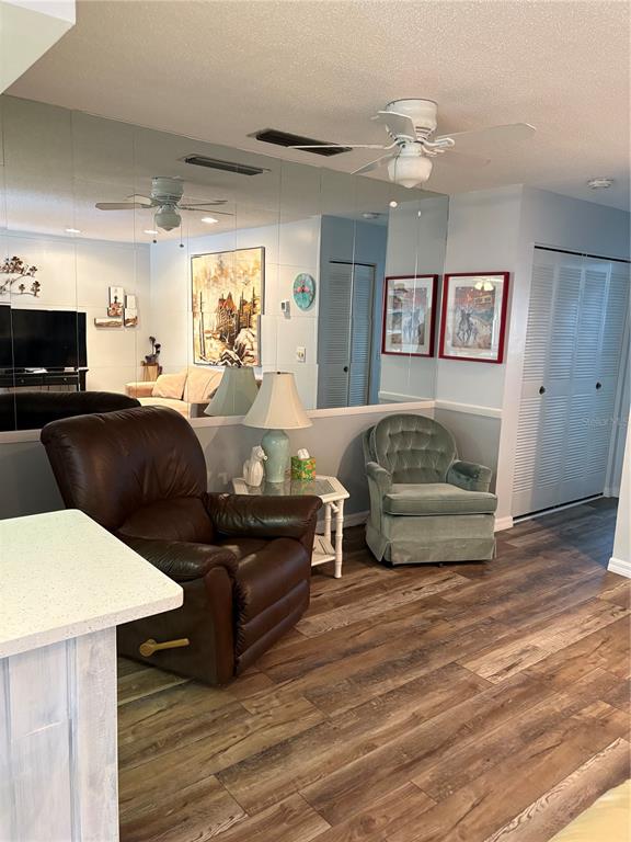 14531 Walsingham Road, Unit 204 Largo, FL 33774 - Photo 8 of 29 a living room with furniture and a wooden floor