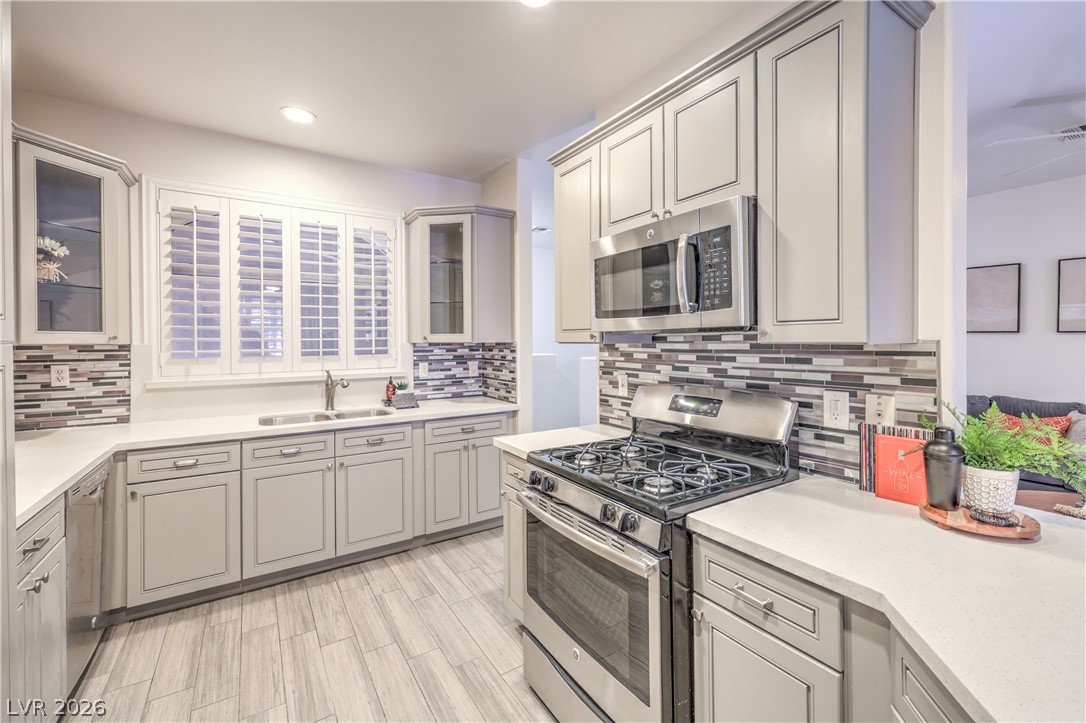 2050 West Warm Springs Road, Unit 1421 Henderson, NV 89014 - Photo 16 of 45 A contemporary kitchen features sleek cabinetry, a gas range, and ample counter space for culinary endeavors.