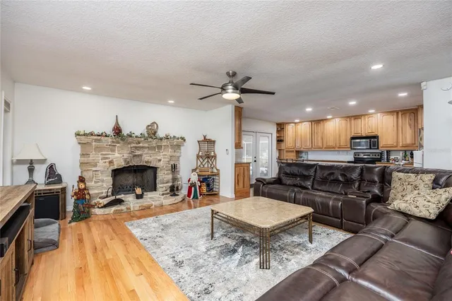 a living room with furniture and kitchen view