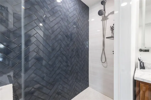 an empty room with windows and ceiling fan