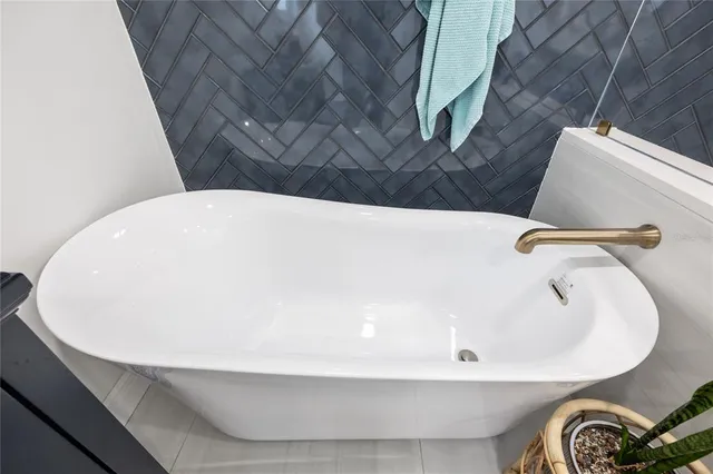 a view of a big room with a ceiling fan and windows