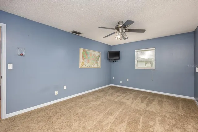a living room with furniture a flat screen tv and a window
