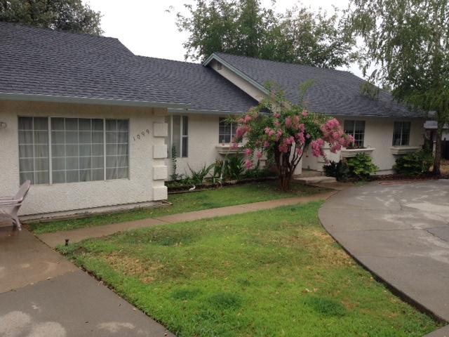 1099 Harpole Road Redding, CA 96002 - Photo 3 of 23 a front view of a house with a garden and plants