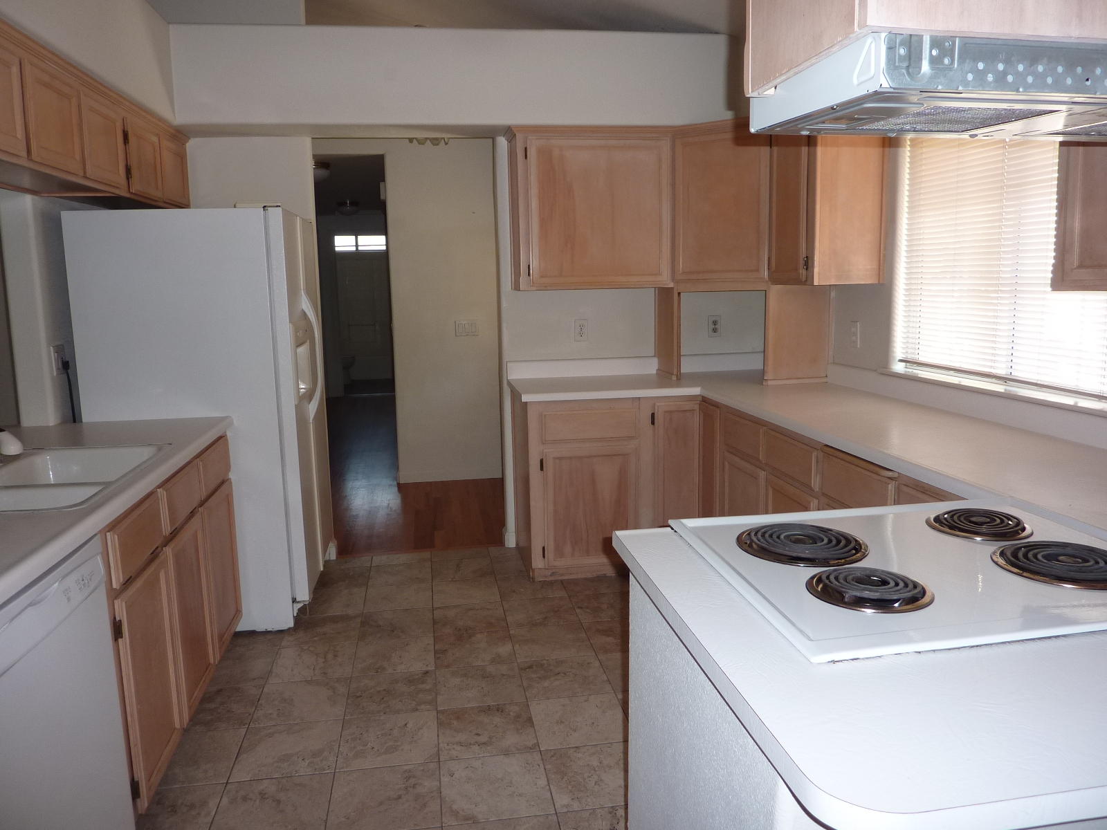 1099 Harpole Road Redding, CA 96002 - Photo 8 of 23 a kitchen with a sink a refrigerator and window