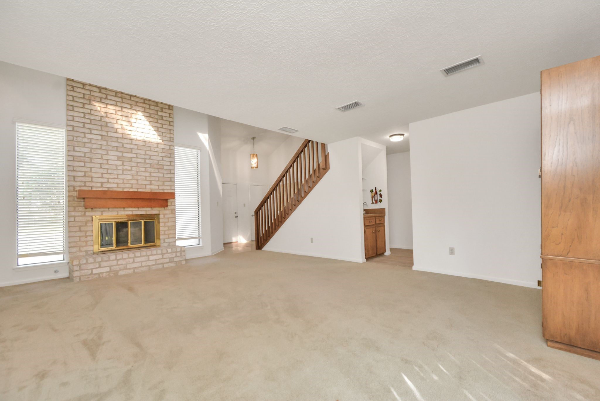 4743 Sabrina Drive Houston, TX 77066 - Photo 12 of 22 an empty room with a fireplace and entryway