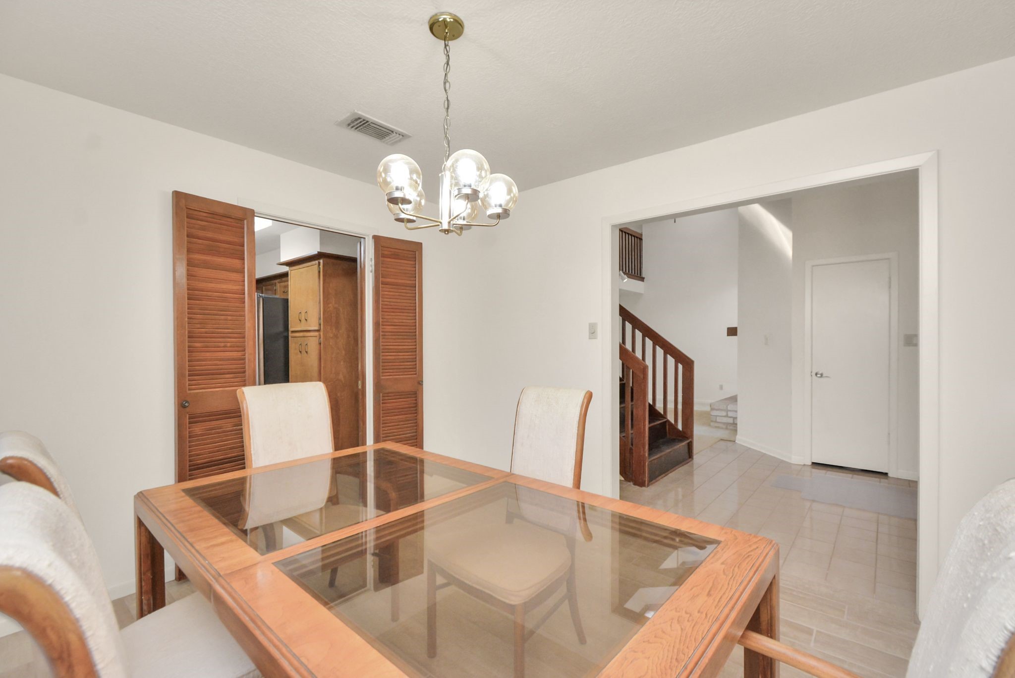 4743 Sabrina Drive Houston, TX 77066 - Photo 4 of 22 a view of a dining room and a livingroom with furniture wooden floor a chandelier
