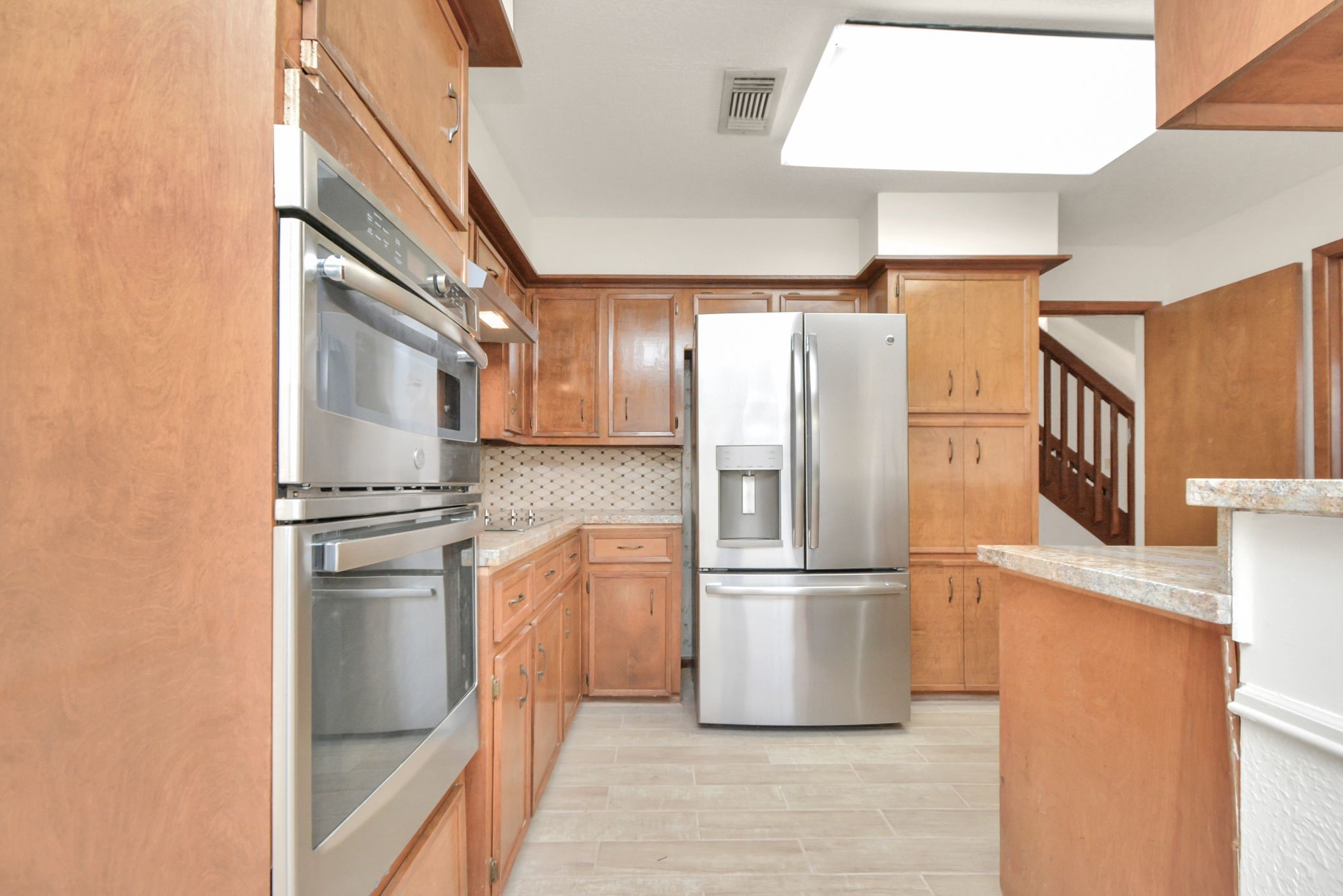 4743 Sabrina Drive Houston, TX 77066 - Photo 6 of 22 a kitchen with stainless steel appliances granite countertop a refrigerator and a stove